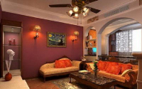 A living room with a red shade